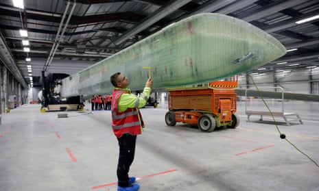 An employee performs quality control checks on a wind turbine blade at the Siemens AG plant in Hull, UK