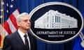 Merrick Garland in front of a US flag and the Department of Justice seal.