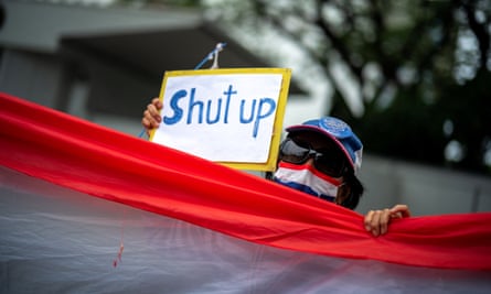 A pro-royalist activist holds a protest sign in front of the US embassy 