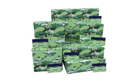 Green wrapping paper depicting a small countryside village