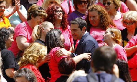 Prime Minister Alexis Tsipras hugs finance ministry cleaners who were laid-off in 2013 but rehired on Thursday.