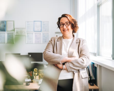 Portrait of smiling person in glasses and suit in the office
