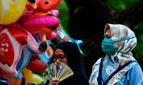A woman wears a face mask in Banda Aceh