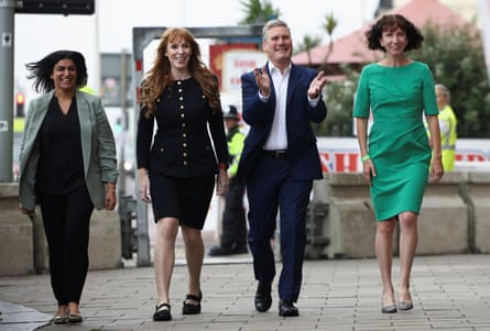 Mahmood, Rayner, Starmer and Dodds smile as they walk towards the camera
