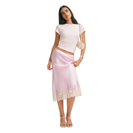 A model wears Reformation Carolina pink Silk Skirt with a white T-shirt