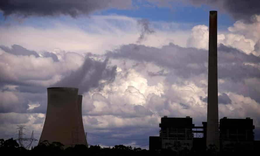 Storm clouds can be seen behind chimneys at the Bayswater coal-powered thermal power station located near the central New South Wales town of Muswellbrook, Australia