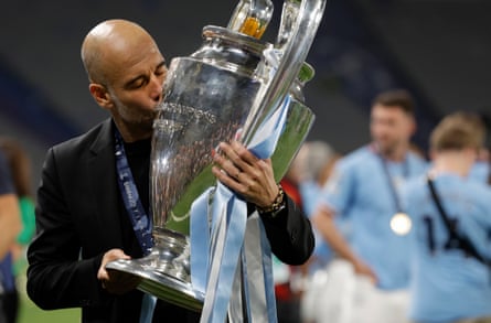 Pep Guardiola kisses the Champions League trophy