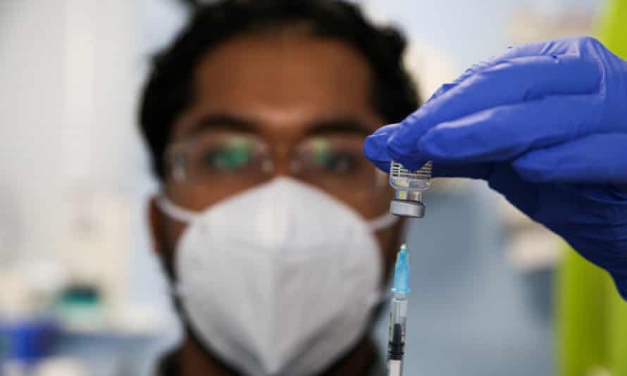 A healthcare worker prepares a dose of Pfizer vaccine