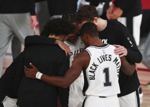 San Antonio Spurs guard Lonnie Walker IV has ‘Black Lives Matter’ printed on the back of his jersey in a huddle before an NBA game against the Sacramento Kings in Lake Buena Vista, Florida, on 31 July