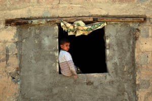A Yemeni child stands inside his house which was damaged in an air-strike in the capital Sanaa.