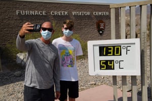 California, US: Tourists take pictures with a thermometer showing the extreme heat in Death Valley.