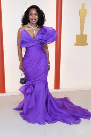 Black Panther: Wakanda Forever nominee Angela Bassett wearing a purple gown from Moschino. It’s a hue historically associated with royalty. The swathed fabric and sparkling snake necklace bring A-lister glamour.