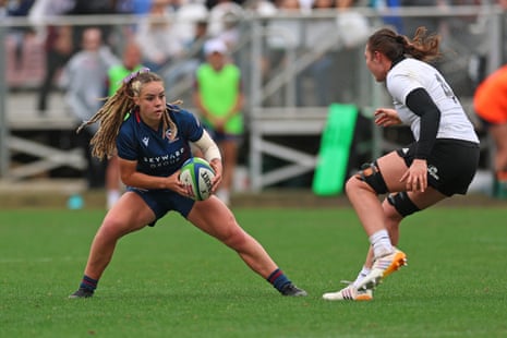 USA's Bella Vogel crouches with the ball as a Black Ferns opponent approaches