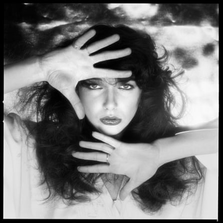Kate Bush posing with hands above and below her face
