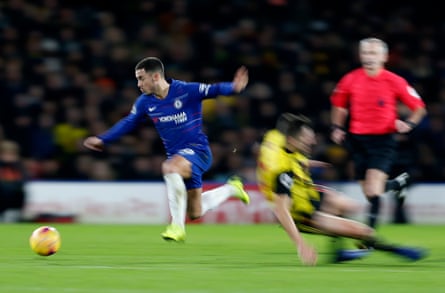 December 26: Eden Hazard of Chelsea leaps away from a tackle by Craig Cathcart of Watford at Vicarage Road.