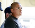 Marine Devin Jacob Ballard looks sideways while escorted by a uniformed officer