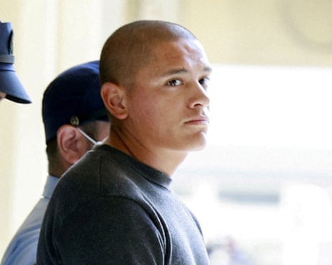 a man is escorted by a uniformed officer