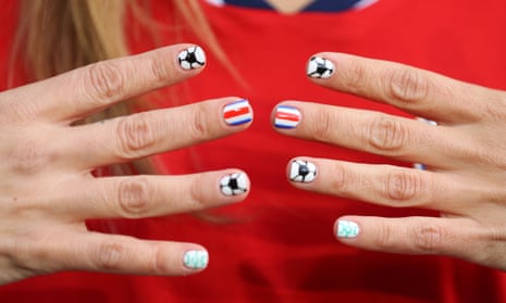 A Costa Rica fan shows off their patriotic nails.