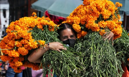 A woman transports cempasuchil (marigold) flowers ahead of Day of the Dead celebrations in Mexico City.