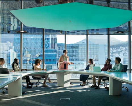 Businesspeople having meeting in large futuristic board room