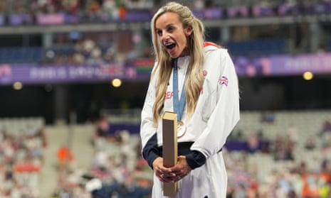 Georgia Bell celebrates on the podium with her bronze medal