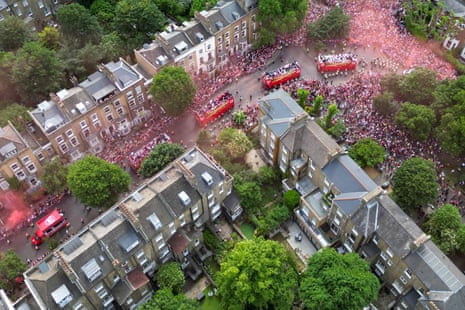 An aerial view shows Arsenal supporters filling the streets to cheer on the team buses