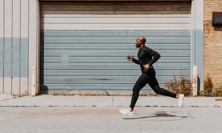 Side view of man jogging in city