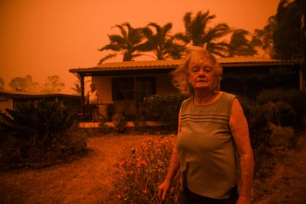 Nancy Allen and Brian Allen stand outside the house as high winds push smoke and ash towards Nowra, New South Wales, Australia, in January 2020.