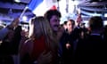 Supporters of presidential party RE Renaissance watch France's president Emmanuel Macron on a screen