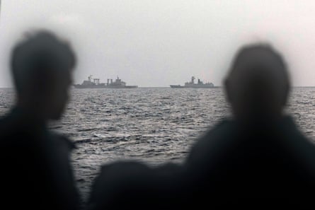 Sailors onboard the Royal Australian Navy ship HMAS Arunta look at the People’s Liberation Army-Navy (PLA-N) Fuchi-class replenishment vessel and Weishanhu Jiangkai-class frigate Hengyang in the Tasman Sea.