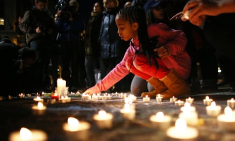 A young girl lights a candle at the Place de la Bourse in Brussels on 22 March, following the terror attacks in the city