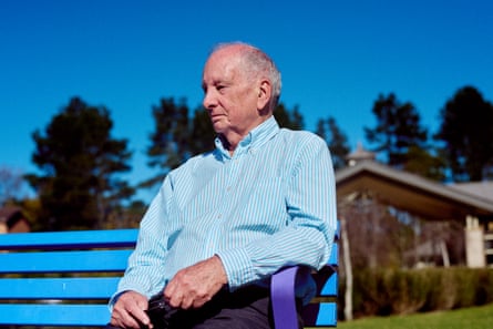 Andrew sitting on a bench outside.