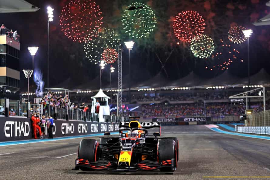 Fireworks light up the sky behind Max Verstappen’s car after his dramatic Abu Dhabi GP victory.