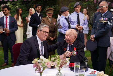 Keir Starmer speaks to second world war veteran Stanley Ellis as he hosts a VJ Day commemorative reception in the Downing Street garden in London on Thursday.