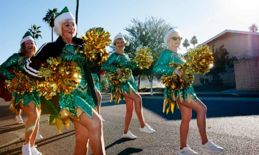 Members of the Sun City Poms cheerleading group practise marching and dancing in unison before a performance