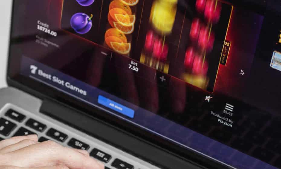 Person at a computer keyboard playing fruit machine slots