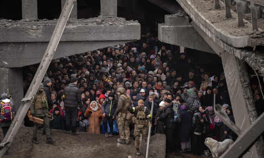 Ukrainians packed under a damaged bridge