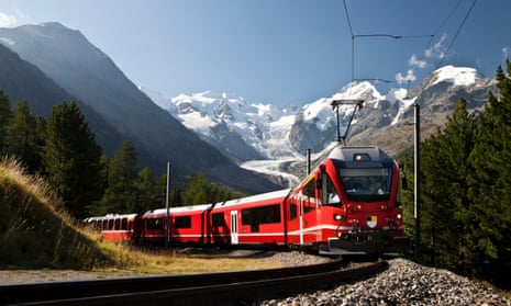 red Swiss train with mountains and glacier in the background