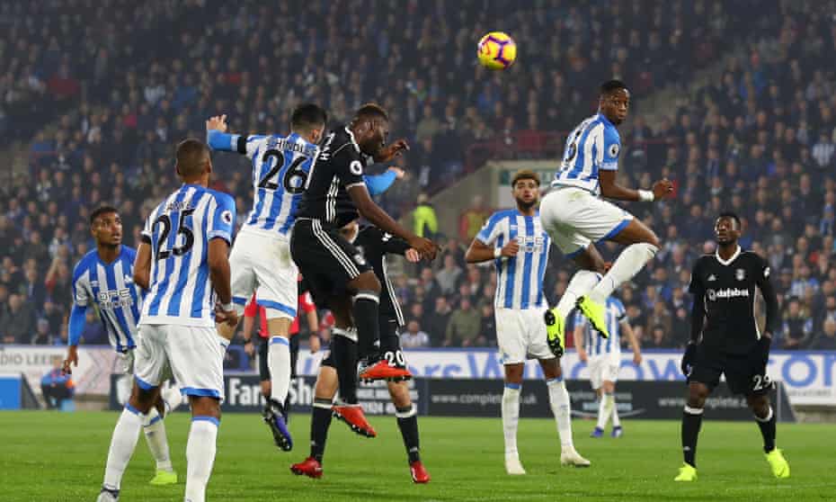 Christopher Schindler (26) and Timothy Fosu-Mensah of Fulham rise together for a Huddersfield corner that led to the home side’s goal.