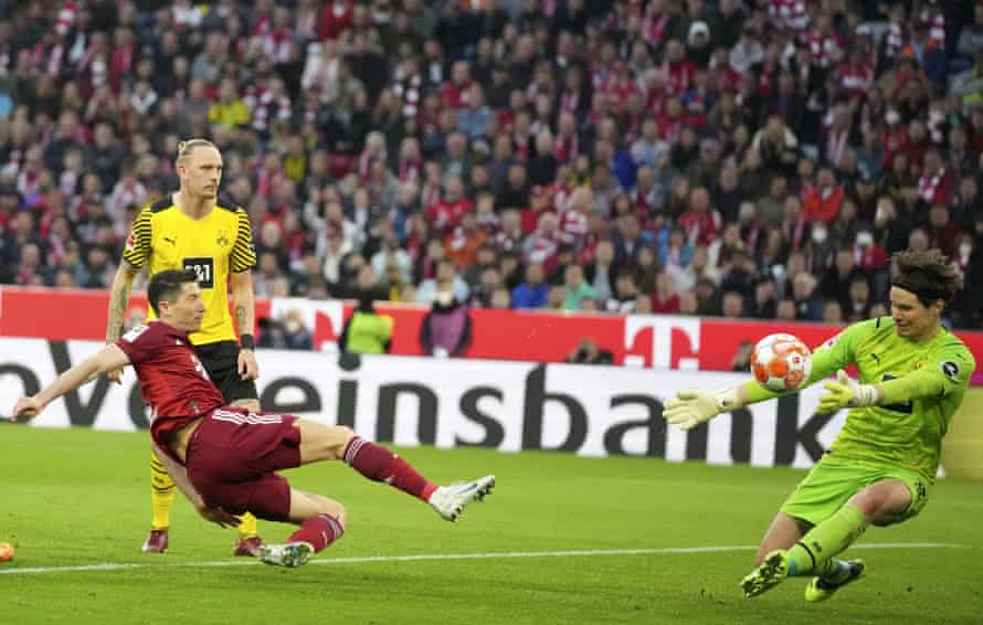 Dortmund's goalkeeper Marwin Hitz makes a save from Bayern's Robert Lewandowski.