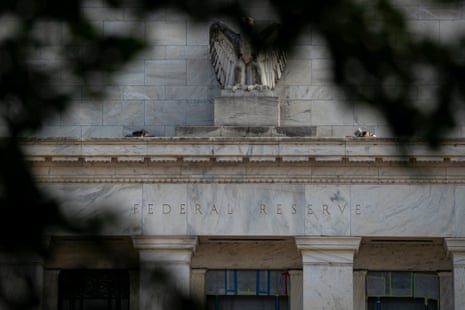 An eagle statue perches above carved "Federal Reserve" lettering on the Washington building's marble facade