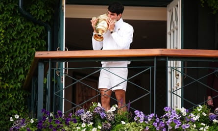 Carlos Alcaraz kisses the Wimbledon men’s singles trophy on the Centre Court balcony