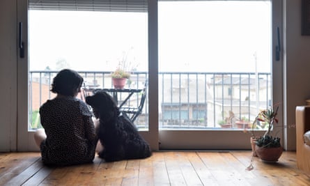 A woman and a dog on the floor of a city flat