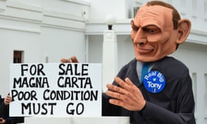 Man dressed as Tony Abbott holds Magna Carta sign