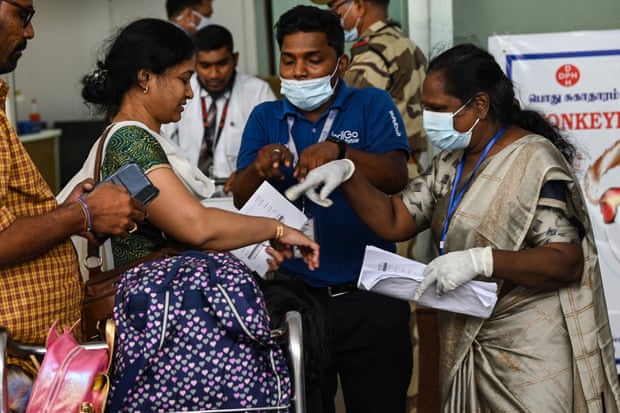 Health workers screen passengers arriving from abroad for monkeypox at Anna International Airport terminal in Chennai, 3 June 2022.