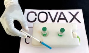 Nurse preparing AstraZeneca vaccine via Covax.