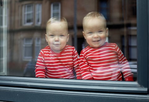 Aven and Reed sit on their bedroom windowsill. They often enjoy sitting here and banging on the window as people pass by. We frequently receive waves and smiles.