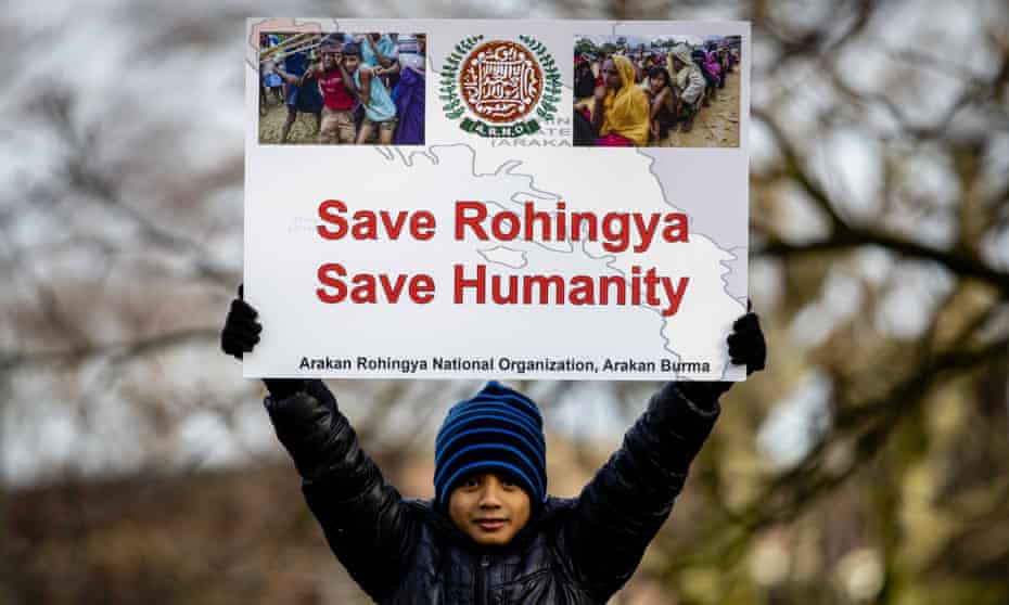 A child holds a sign reading "Save Rohingya, save humanity" during a protest in the Netherlands.