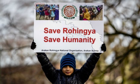 A child holds a sign reading "Save Rohingya, save humanity" during a protest in the Netherlands.