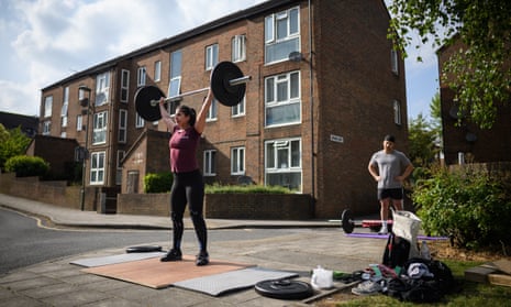 The CrossFit enthusiast Elena Demou and her personal trainer, James Luong, work out by the side of the road in London